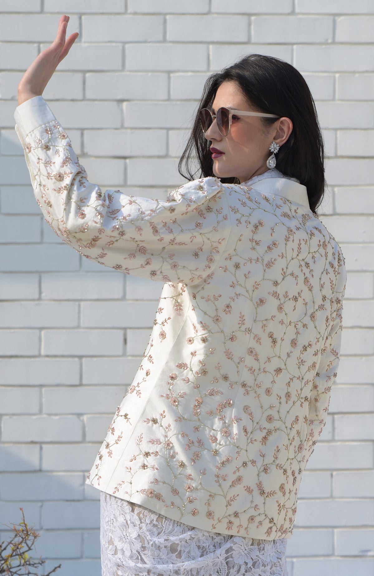 Ivory-pink hand-embroidered structured jacket with floral sequin details.