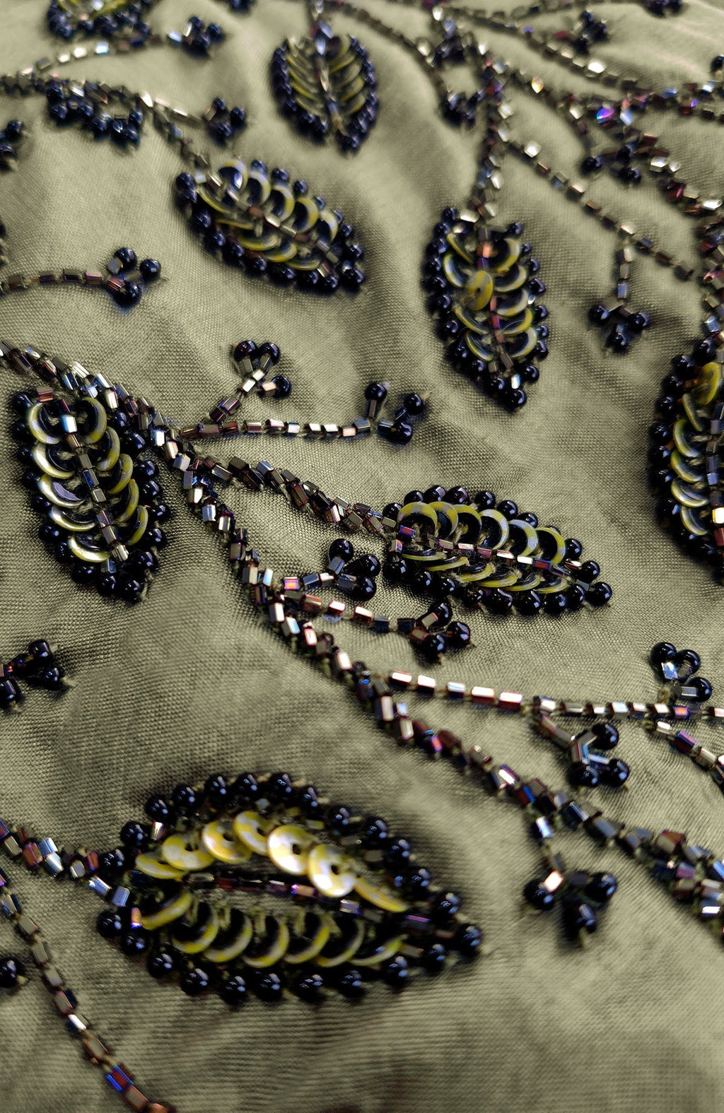 Olive green fabric with dark foliage sequin and bead hand embroidery.