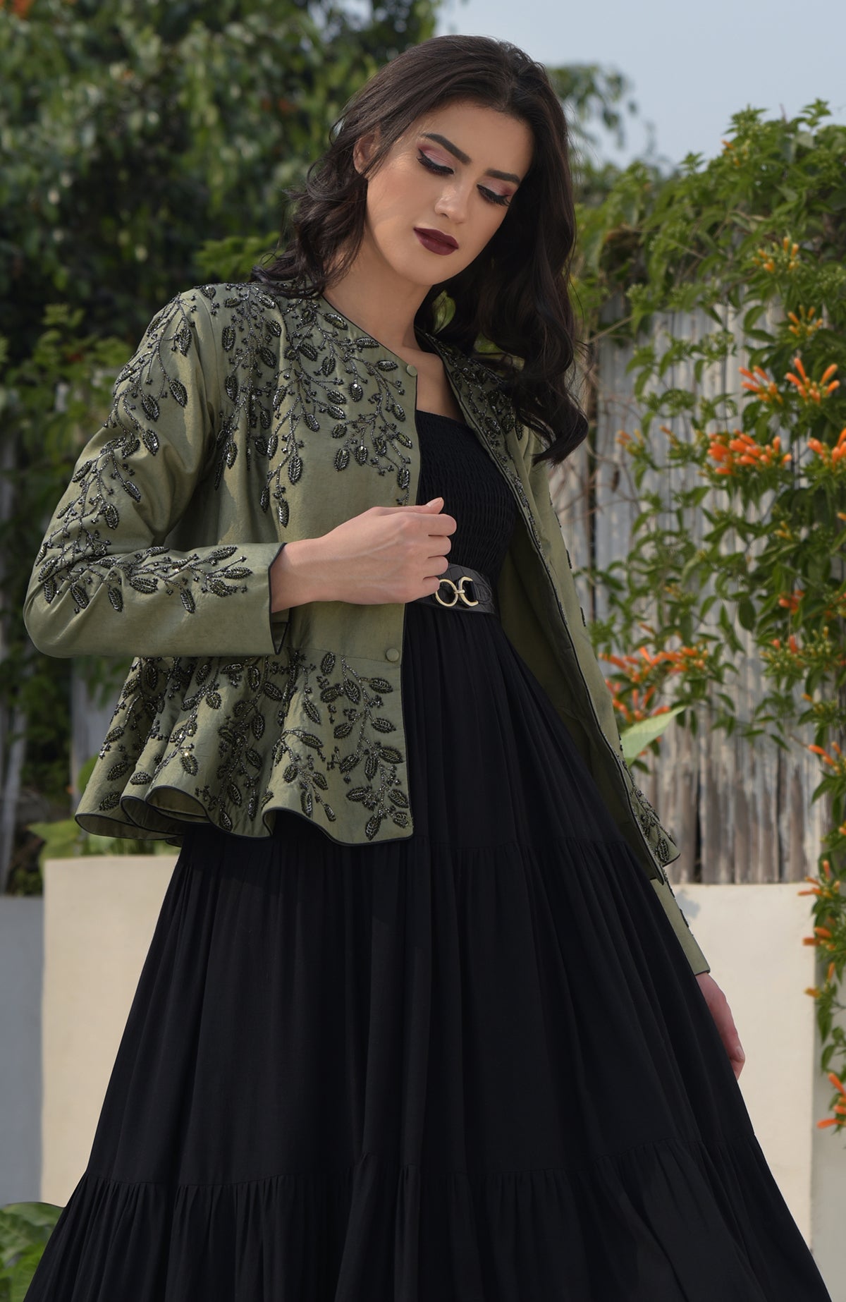 Dark foliage sequin hand-embroidered structured peplum jacket over a black dress.