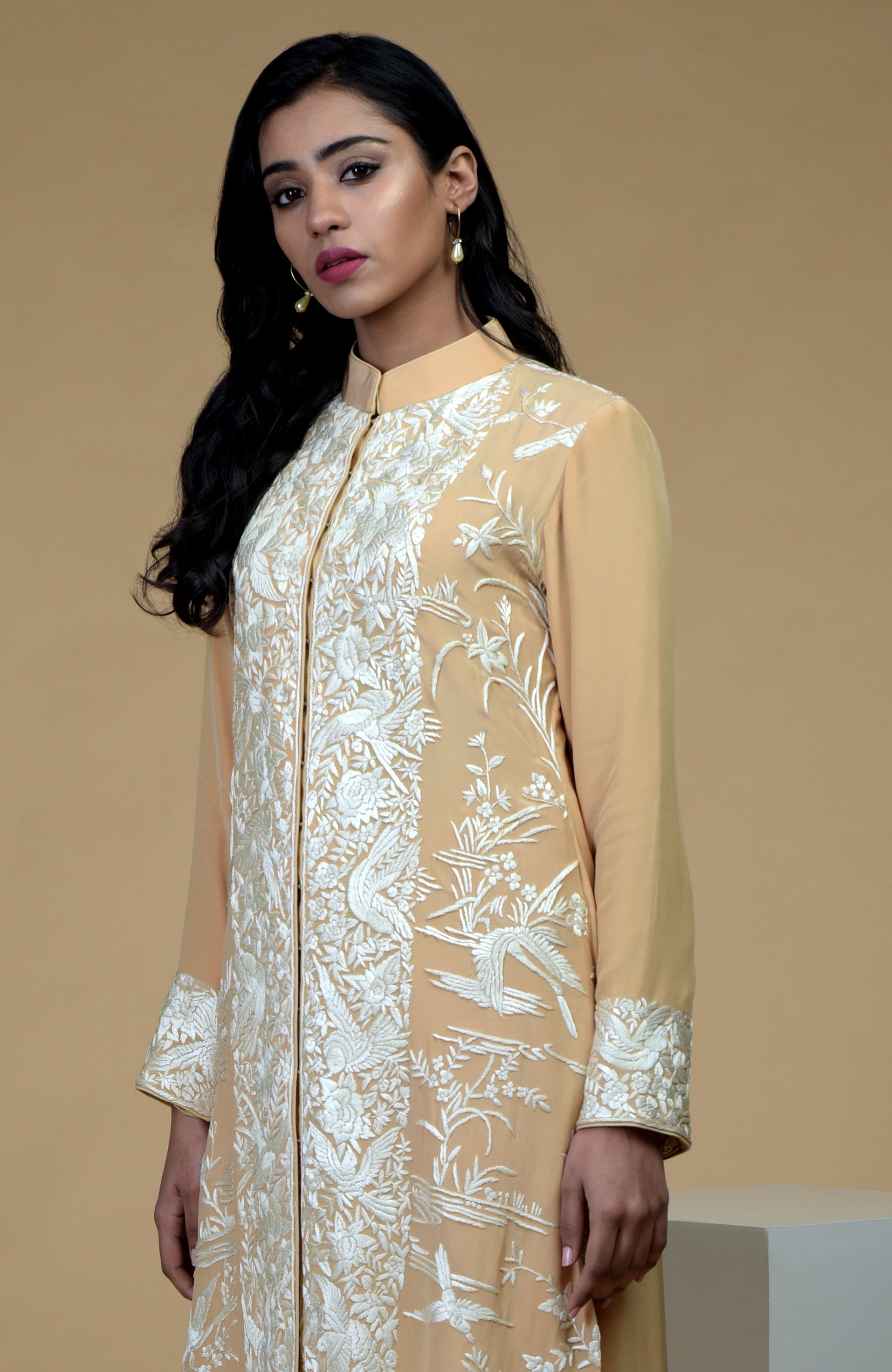 Fawn jacket with ivory Parsi Gara floral-birds embroidery and matching crepe pants.