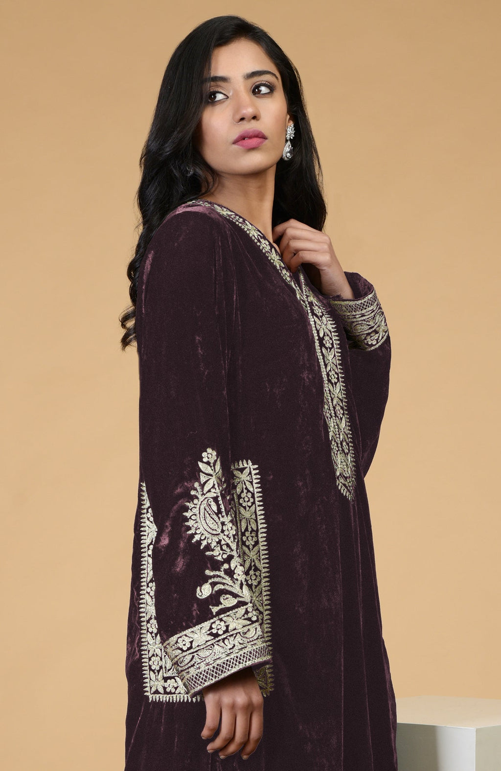 Mulled wine velvet kurta with Kashmiri tilla embroidery on the neckline, sleeves, and pockets.