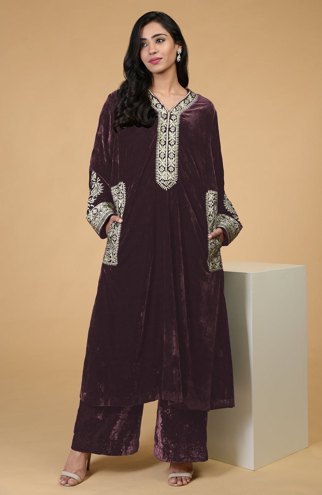 A woman models a mulled wine Kashmiri tilla embroidered choga kurta set.