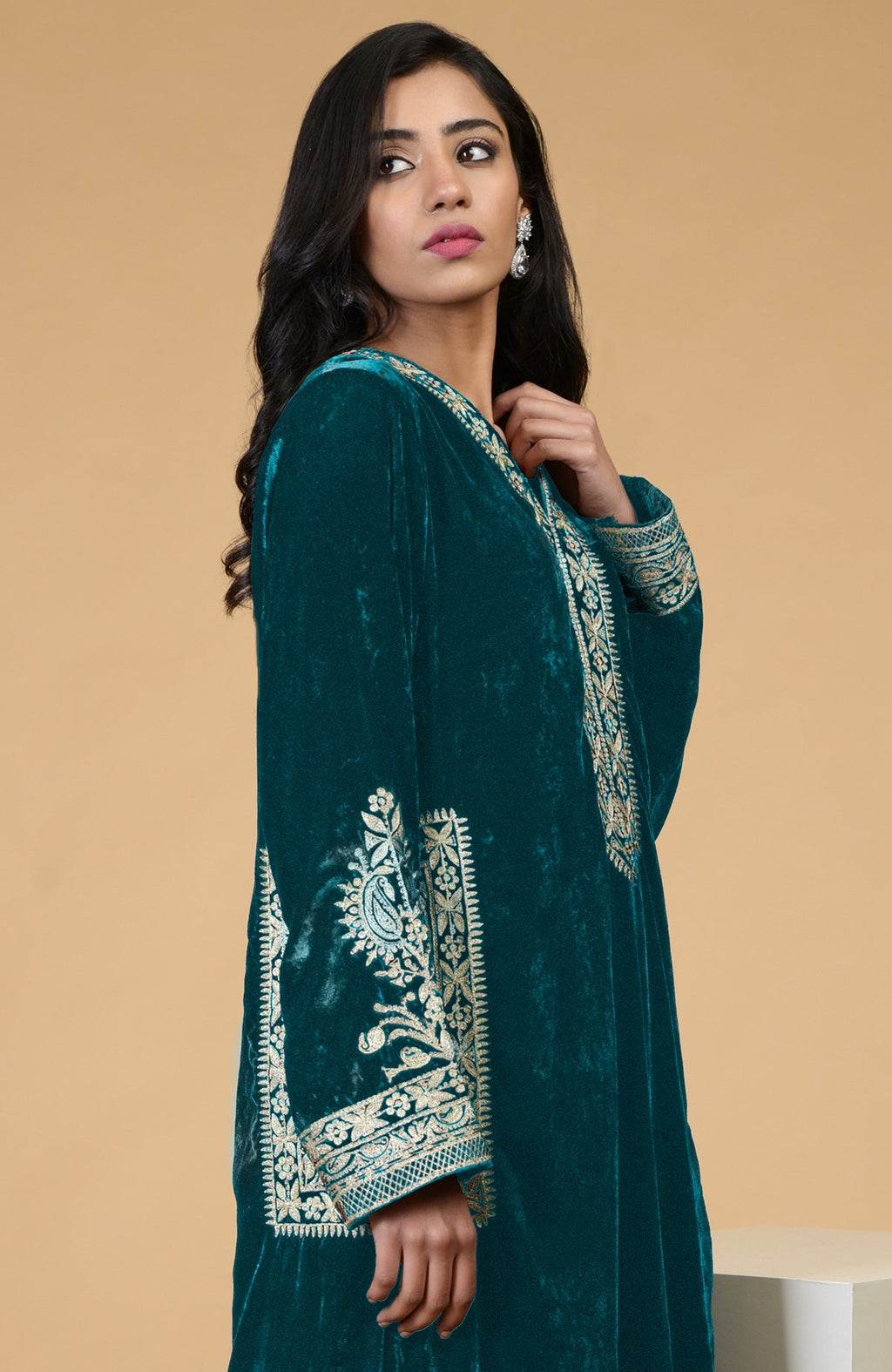 Teal velvet kurta with Kashmiri tilla embroidery on the neckline, sleeves, and pockets.