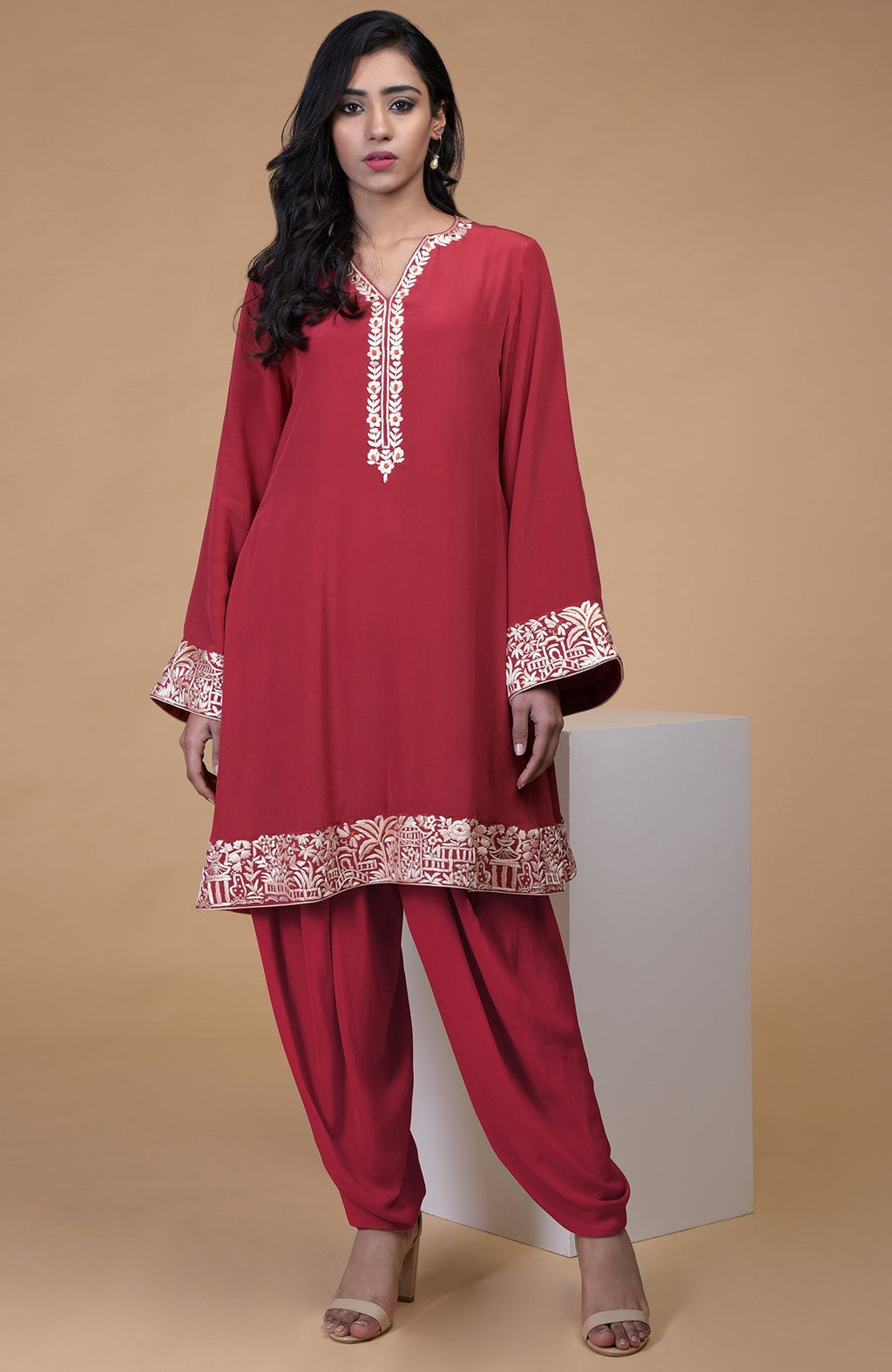 Shiraz red kurta with beige floral parsi gara embroidery on hems and sleeves, paired with matching pants