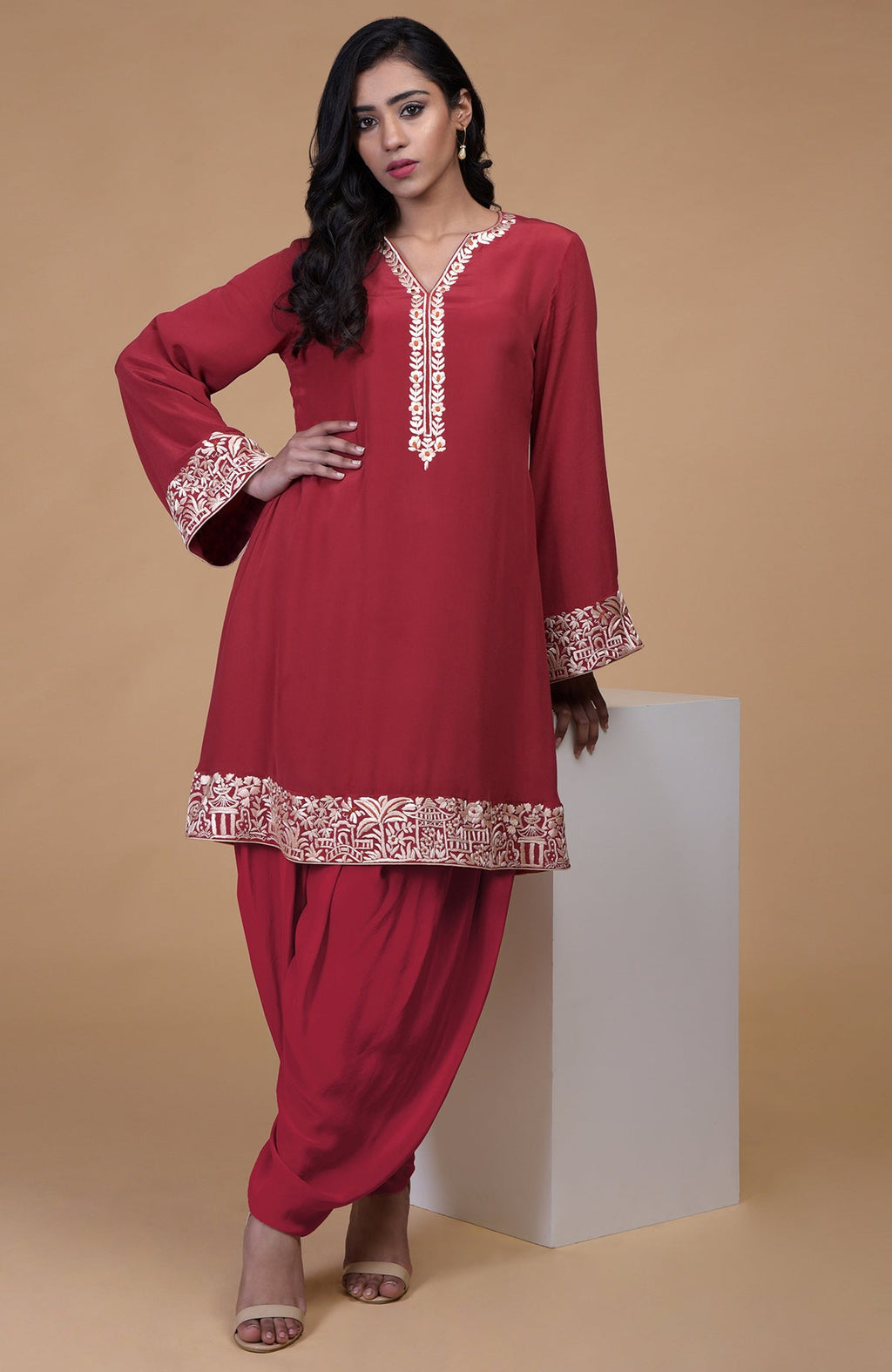 Shiraz red kurta with beige floral Parsi Gara embroidery on hem, neckline, and sleeves paired with dhoti pants