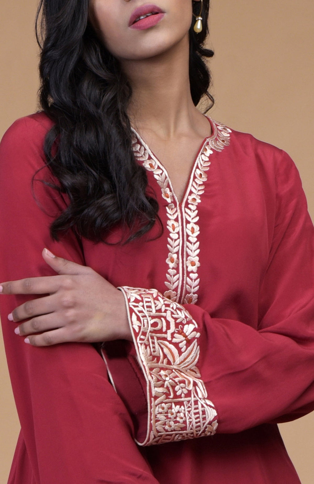 Shiraz red kurta with beige floral Parsi gara embroidery on hem, neckline, and sleeves paired with dhoti pants