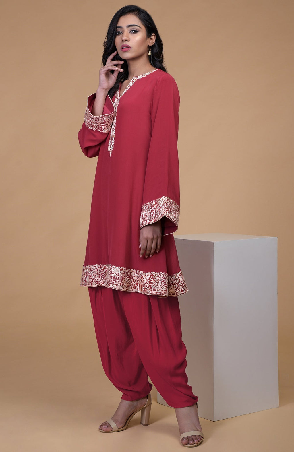 Shiraz red kurta with beige floral parsi gara embroidery on hem, neckline, and sleeves paired with dhoti pants