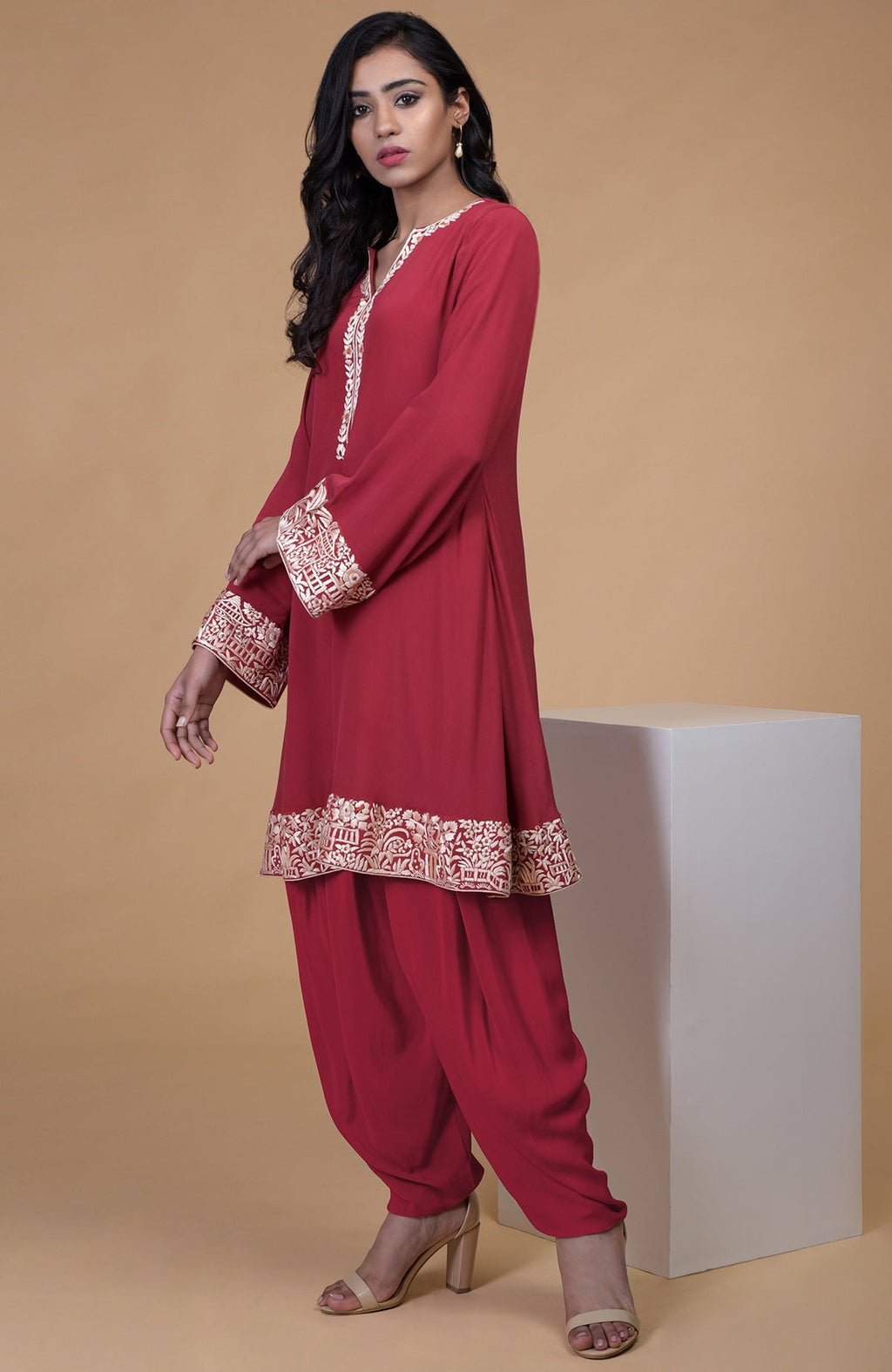 Shiraz red kurta with beige floral Parsi Gara embroidery on hem, neckline, and sleeves paired with dhoti pants