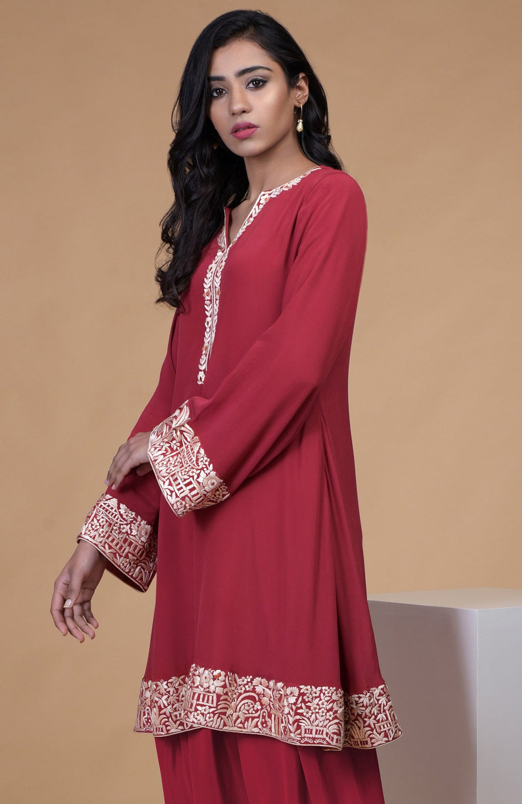 Shiraz red kurta with beige floral parsi gara embroidery on hem, neckline, and sleeves paired with dhoti pants