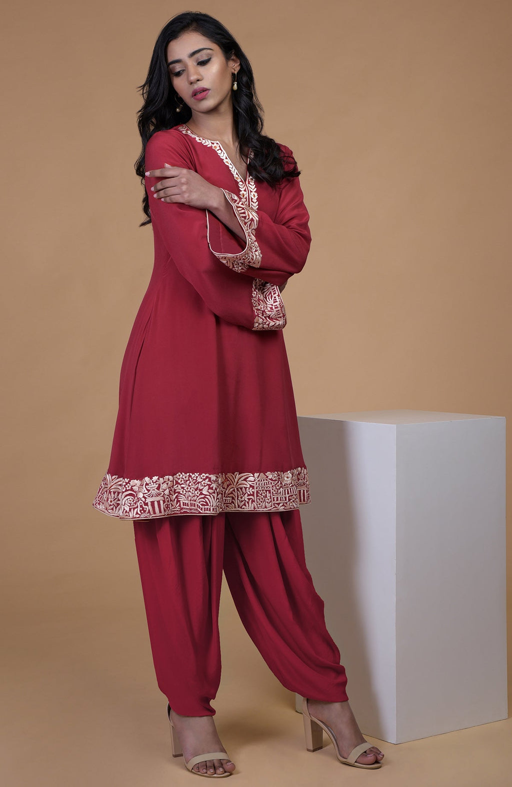 Shiraz red kurta with beige floral parsi gara embroidery on hem, neckline, and sleeves paired with dhoti pants
