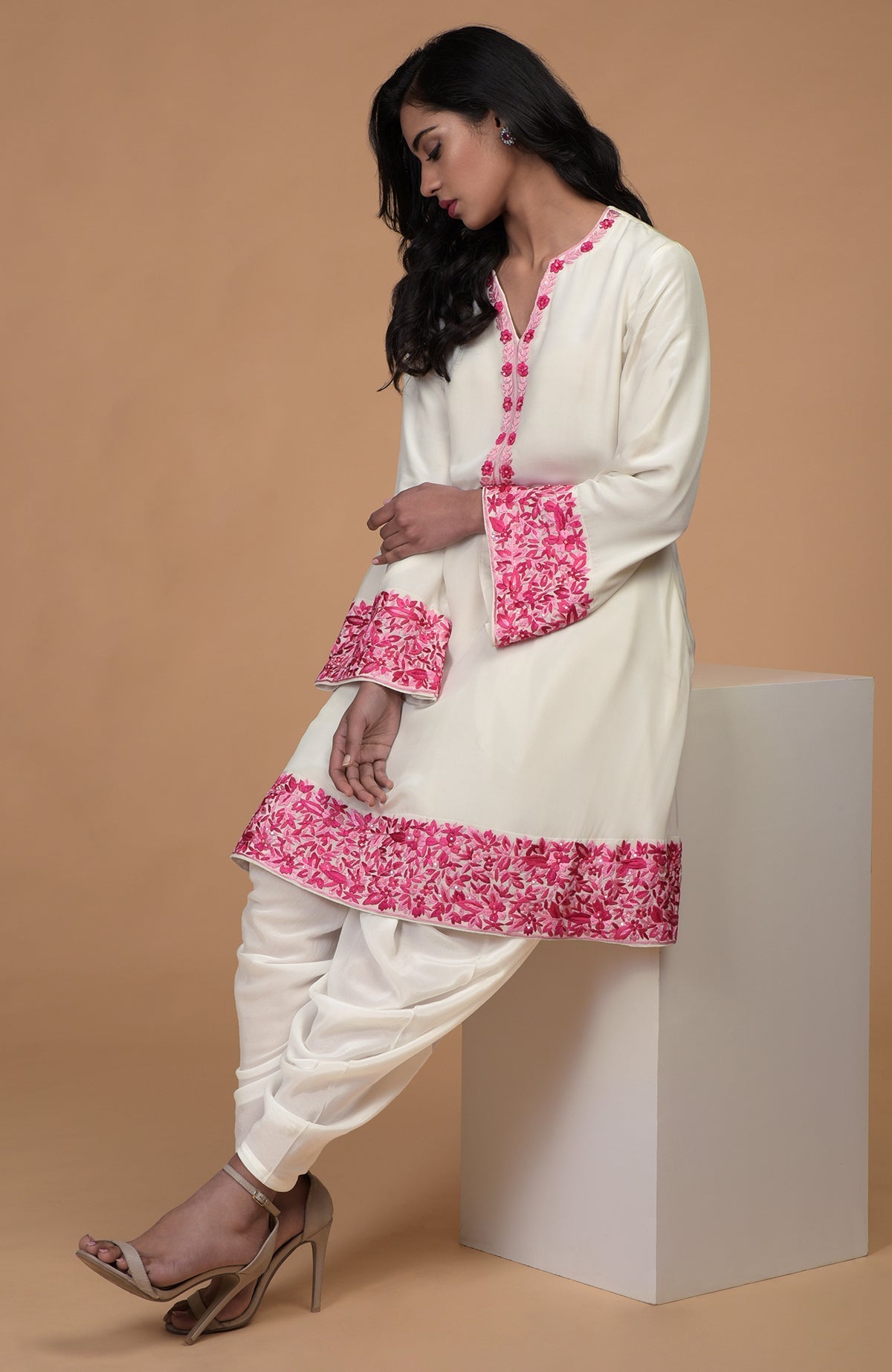 Ivory short kurta with pink Parsi Gara floral embroidery and matching ivory dhoti pants.