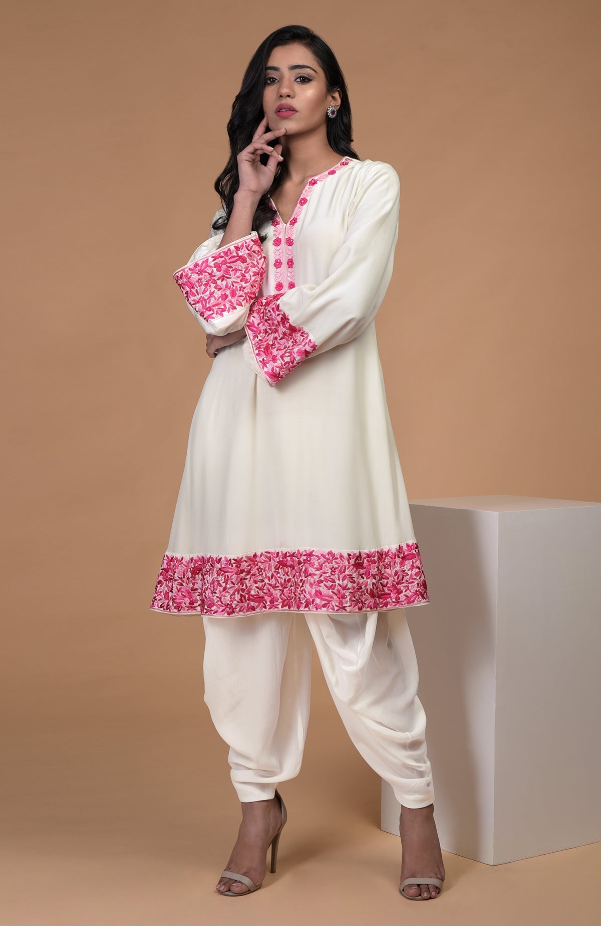 Ivory short kurta with pink floral Parsi Gara embroidery paired with ivory dhoti pants.