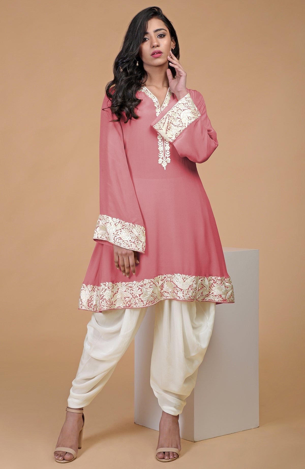 Fawn kurta with ivory Parsi Gara floral embroidery on hem, neckline, and sleeves paired with ivory pants