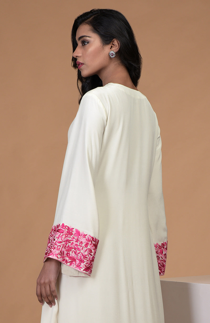 Ivory kurta set with pink Parsi Gara embroidery, bell sleeves, and wide leg pants.