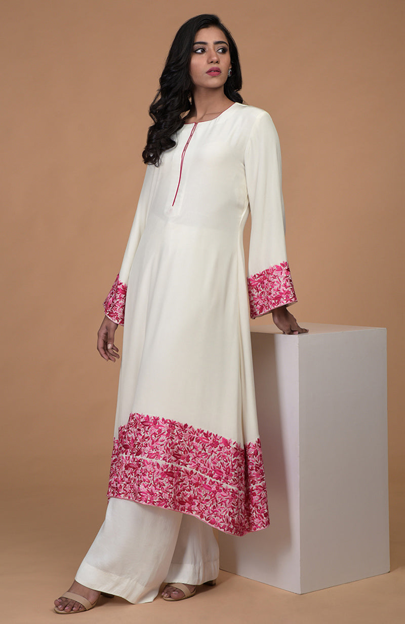 Ivory kurta set with pink Parsi Gara embroidery, bell sleeves, and wide leg pants.
