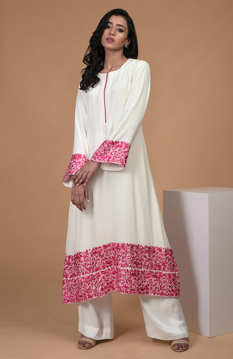 Ivory kurta set with pink Parsi Gara embroidery, bell sleeves, and wide leg pants.