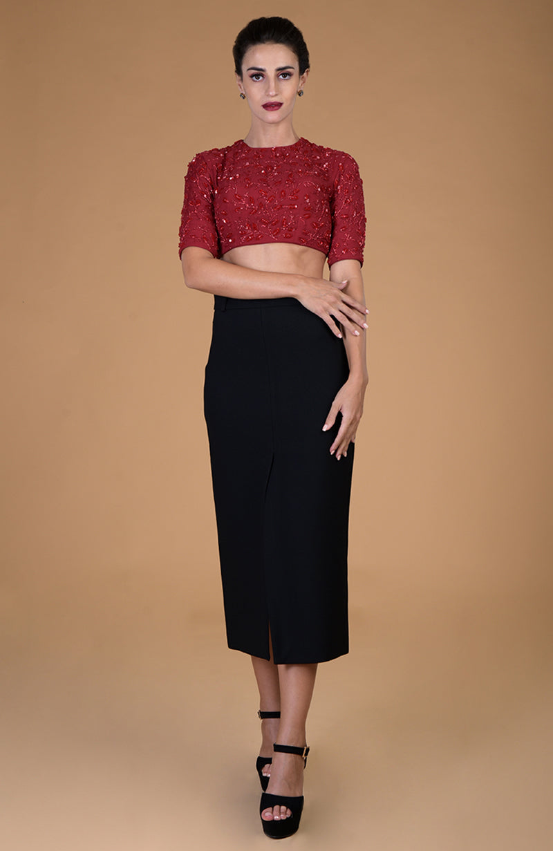 Red foliage hand embroidered blouse with a black skirt and black heels.