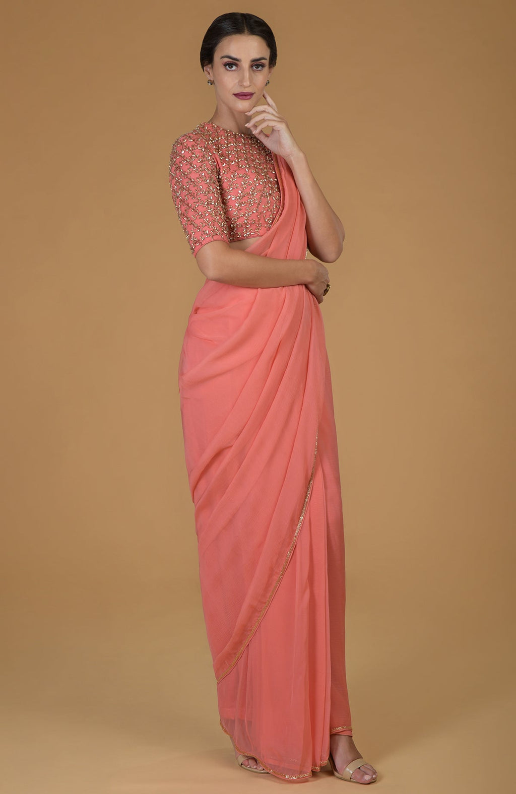 Salmon chiffon saree with a hand-embroidered blouse featuring beads and crystals.