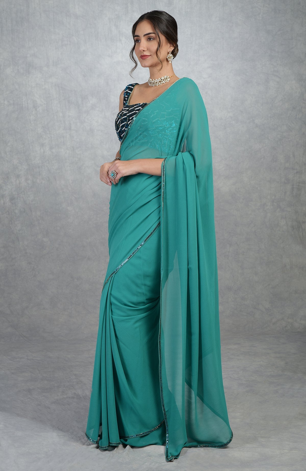 Blue georgette silk saree with a hand-embroidered blouse.