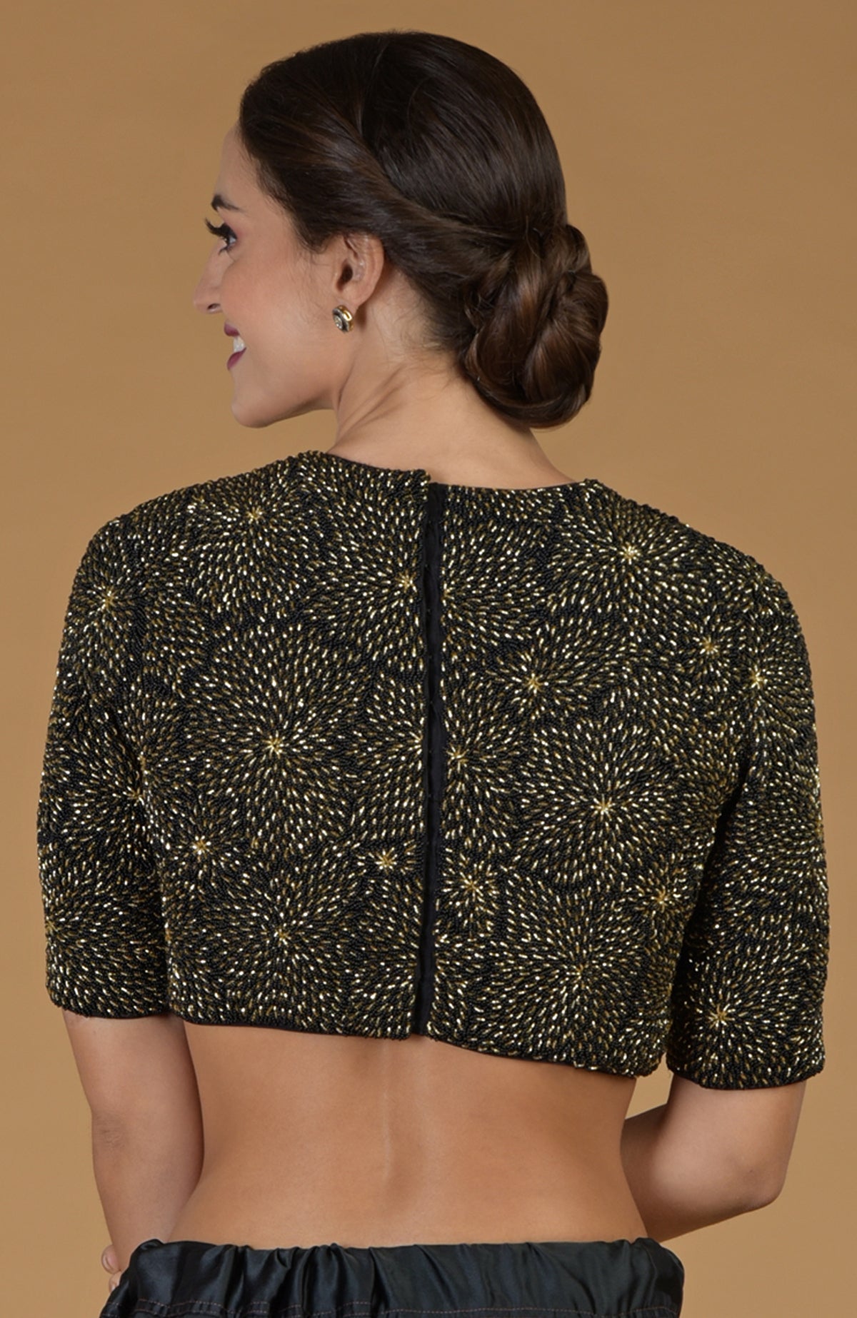 Black and gold hand-embroidered blouse with a back opening.