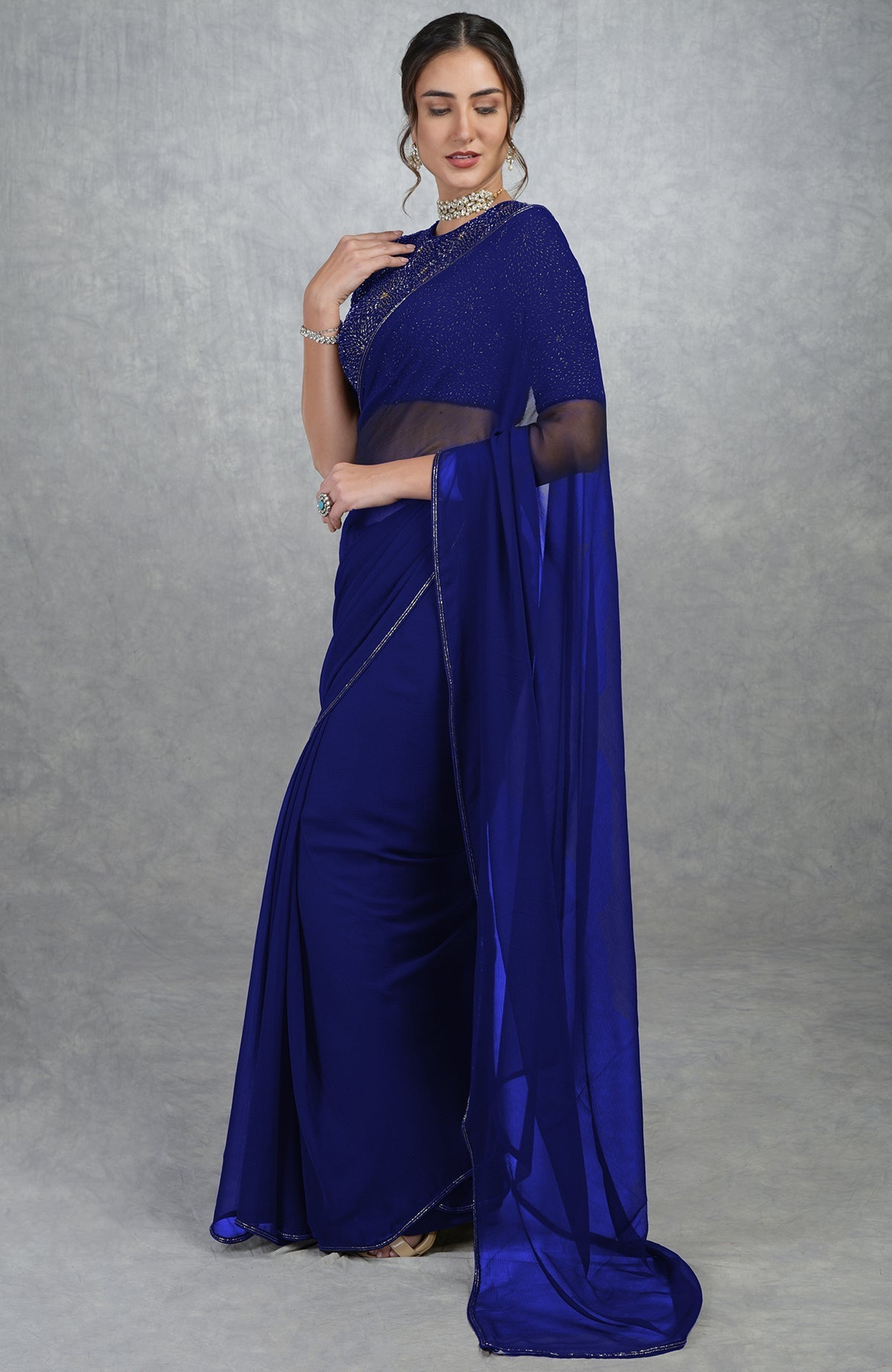Royal blue chiffon saree with gold hand-embroidered blouse.