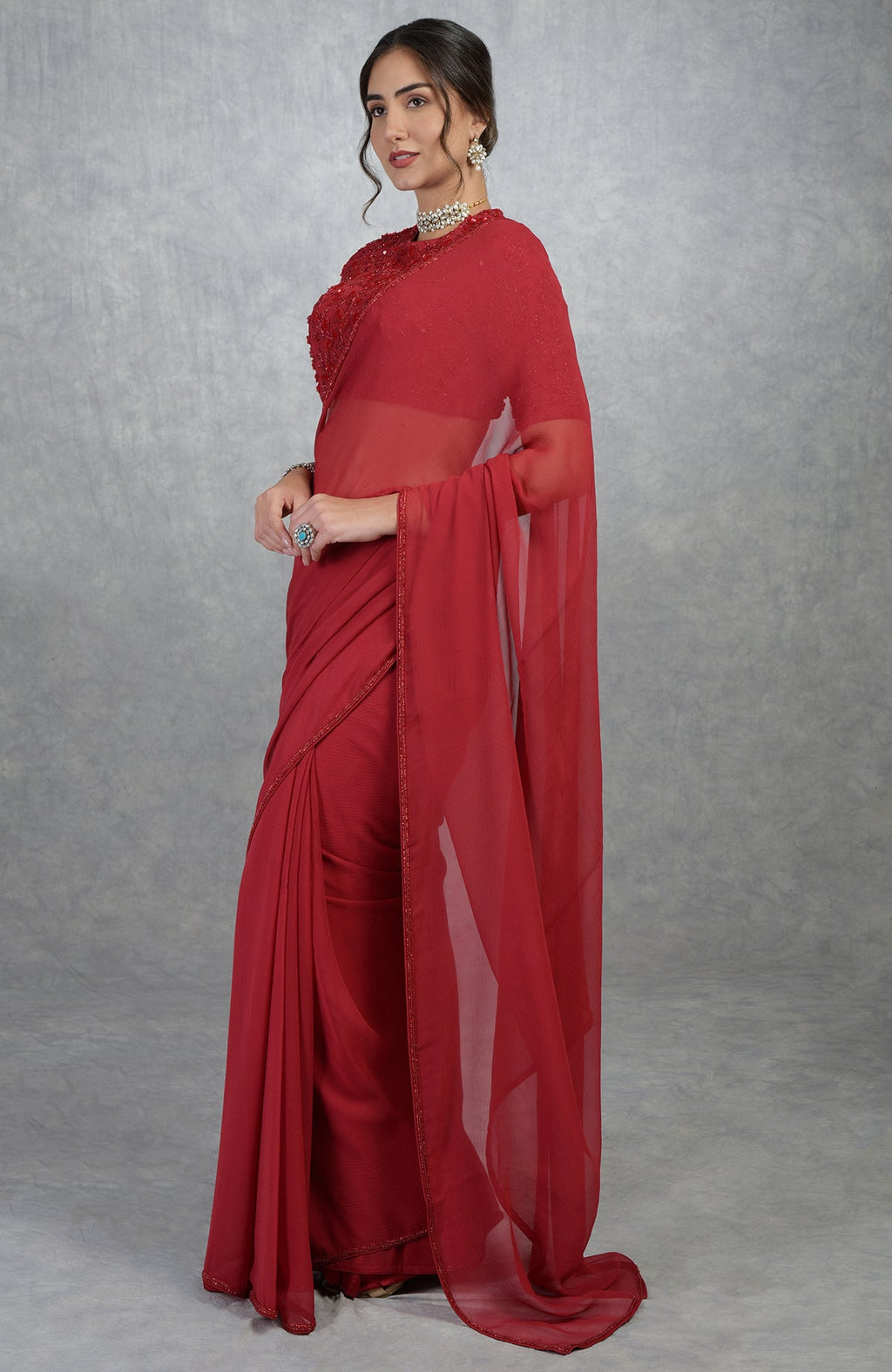 Red chiffon silk saree with a hand-embroidered blouse.