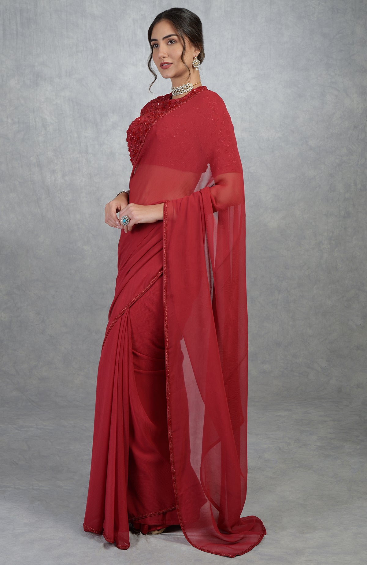 Red chiffon silk saree with a hand-embroidered blouse.