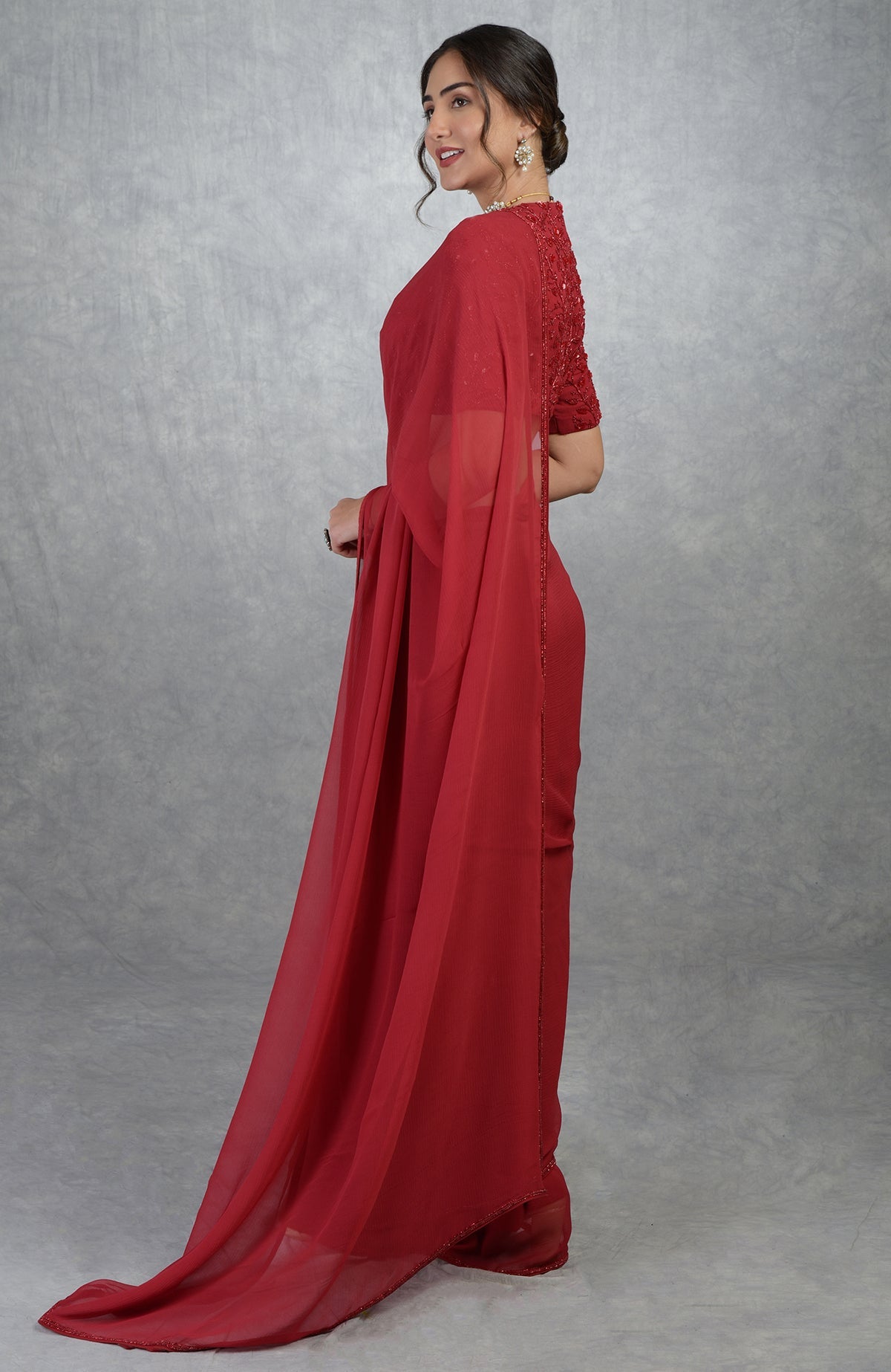 Red pure chiffon silk saree with a hand-embroidered blouse.