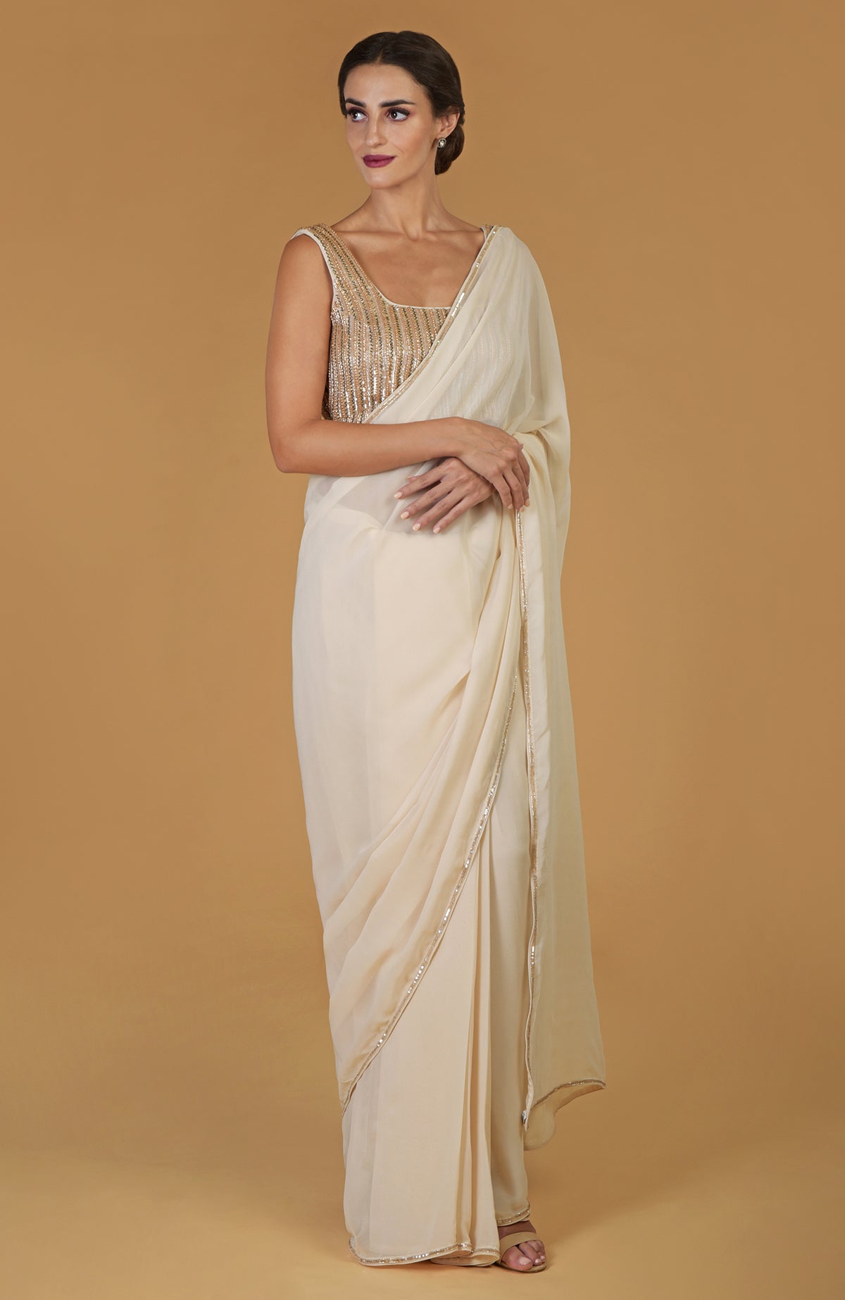 Champagne gold hand-embroidered saree and blouse with bead and crystal work.