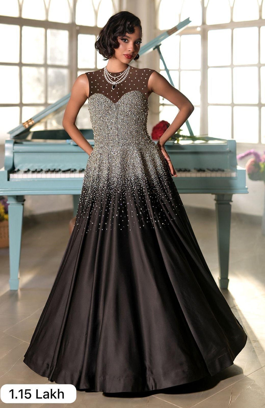 Black satin princess gown with crystal and pearl bead embroidery and a voluminous skirt.