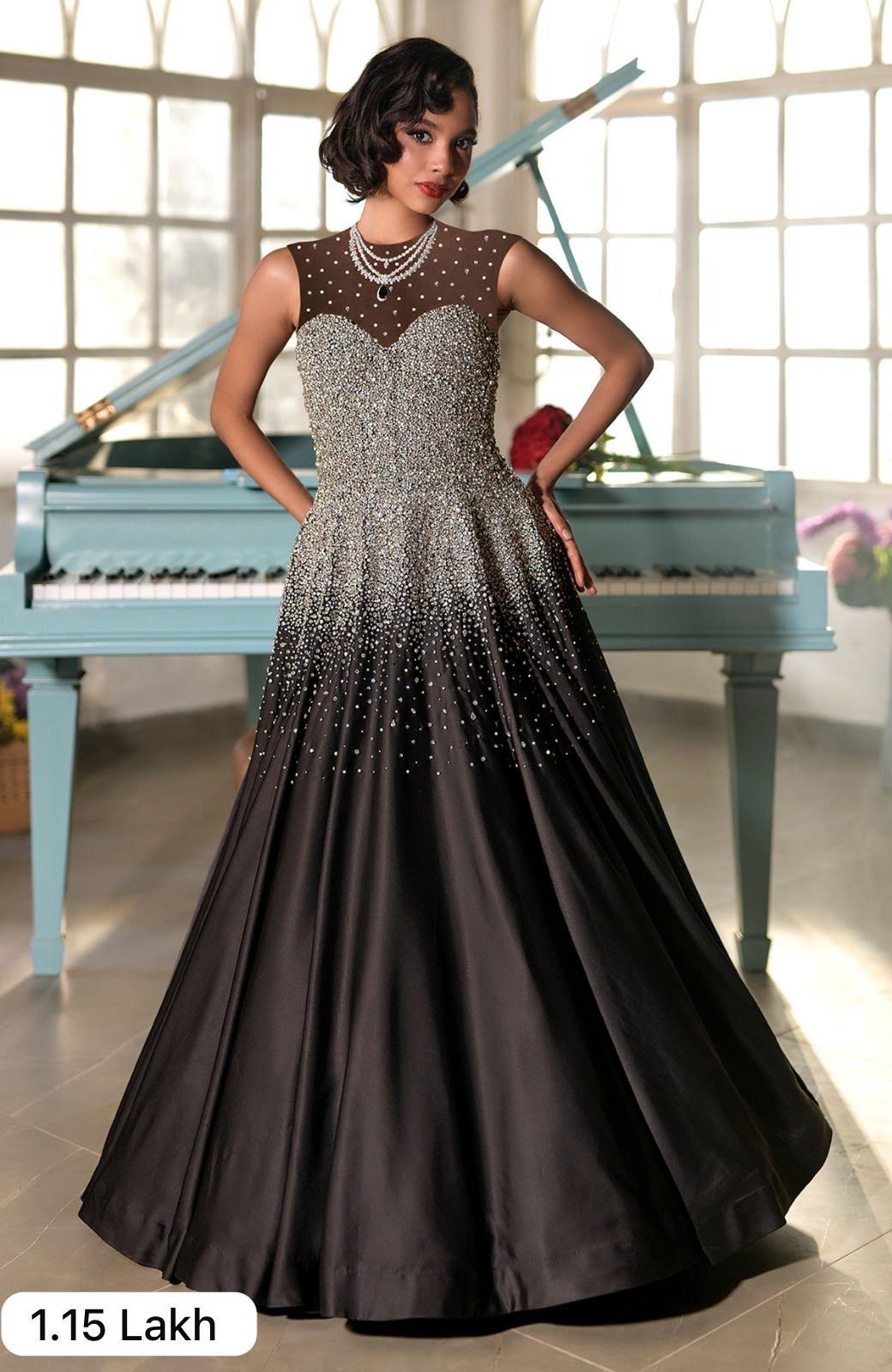 Black satin princess gown with crystal and pearl bead embroidery and a voluminous skirt.