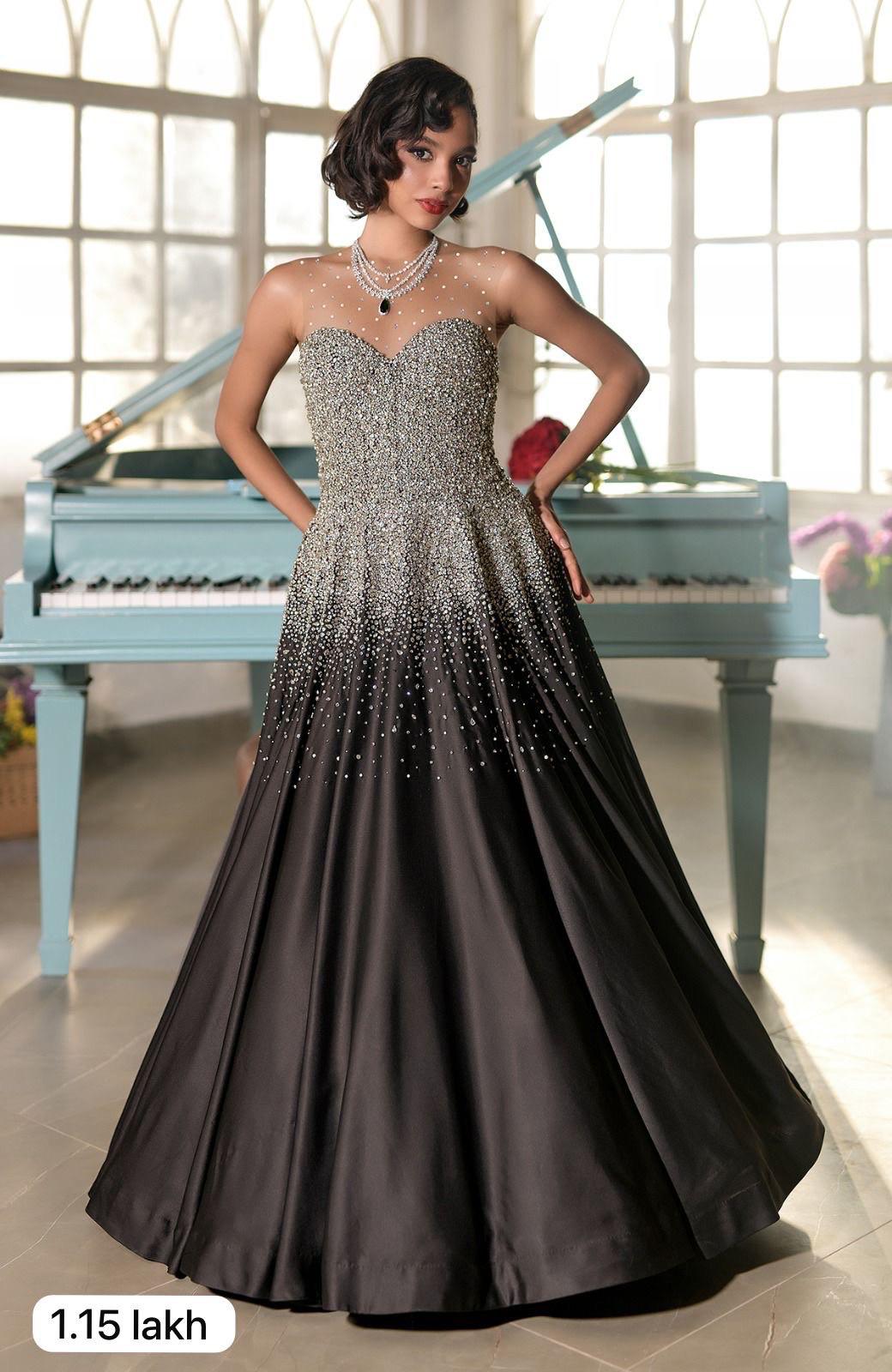 Black satin princess gown with crystal and pearl bead embroidery and a voluminous skirt.