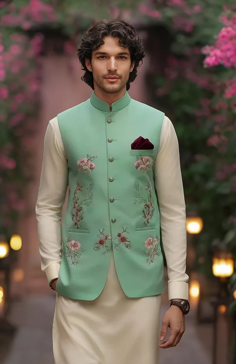 Ivory kurta with full sleeves and slim trousers paired with mint green floral embroidered bandi jacket